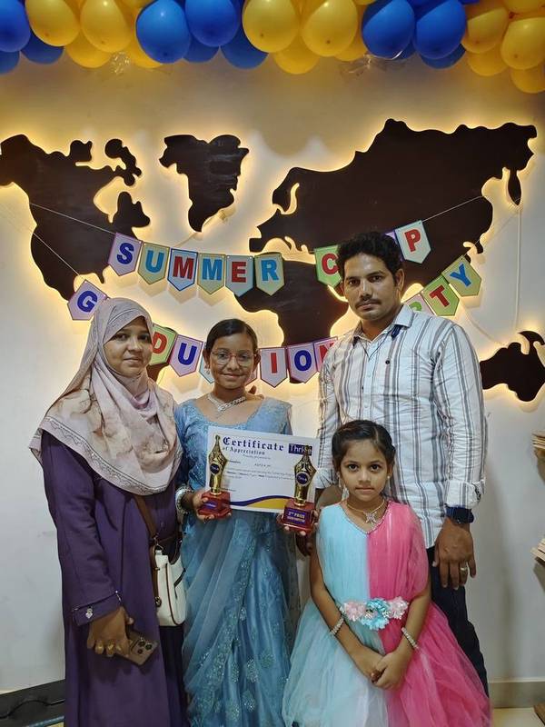 Student with family holding certificates and trophies at Thrive Academy