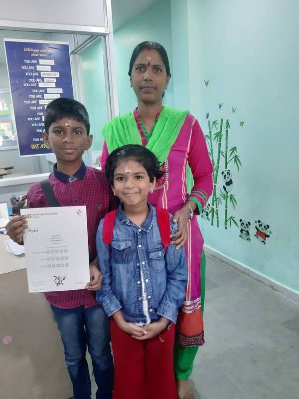 Siblings with a Cambridge English Flyers certificate