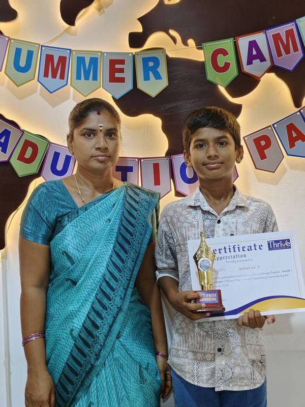 Student with a certificate of appreciation and trophy at Thrive Academy