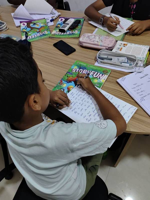 Teacher leading a phonics lesson with an interactive screen