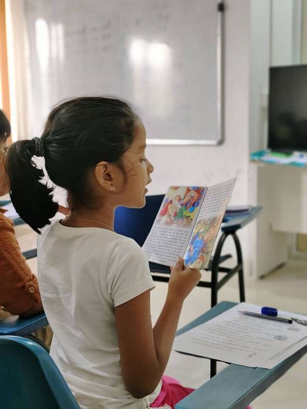 Student writing during a Cambridge Storyfun activity