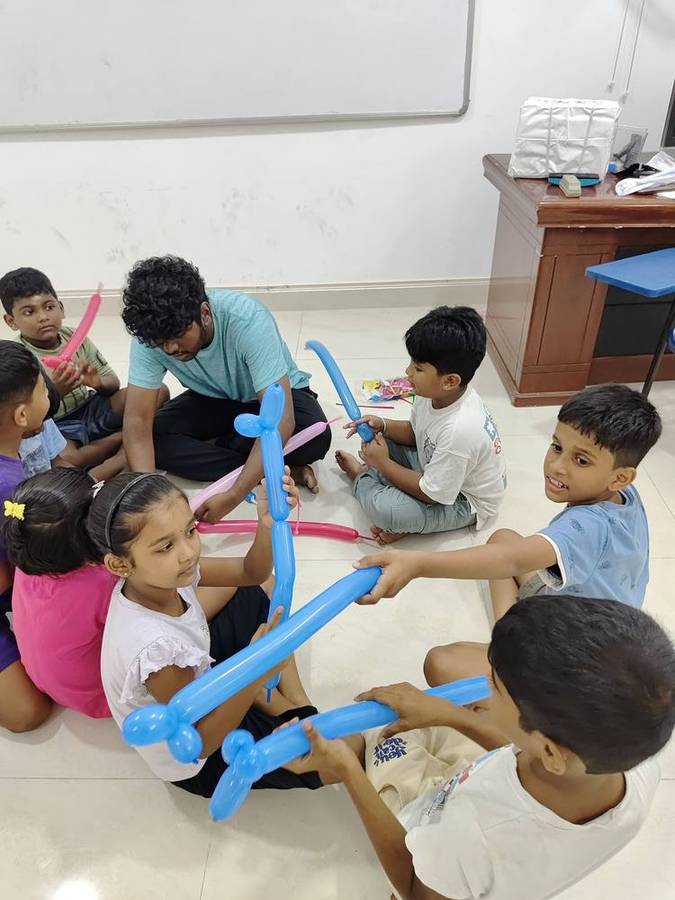 Kids enjoying a balloon-modelling activity at Thrive
